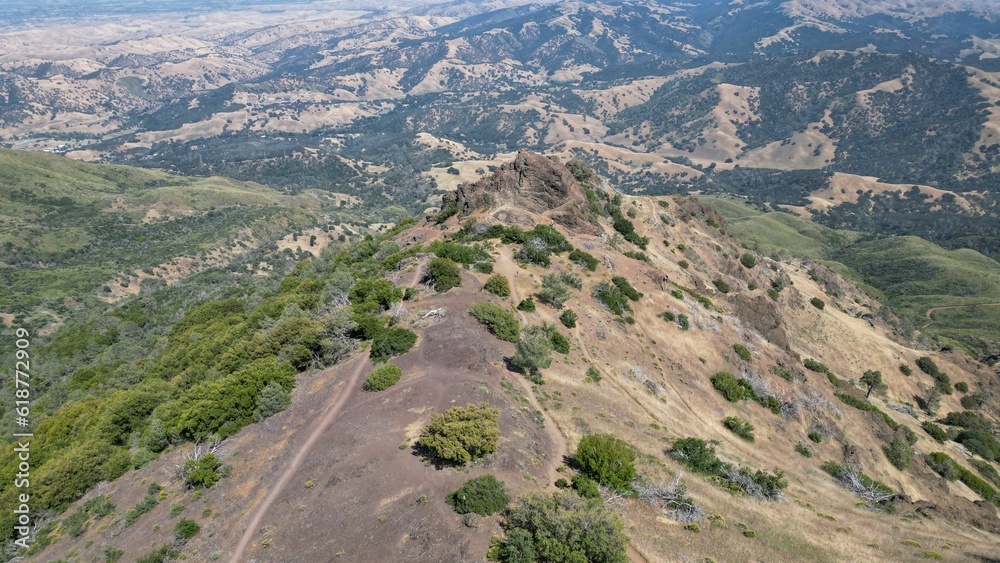an aerial view of a mountain and valley with hills in the background an aerial view of a mountain and valley with hills in the background