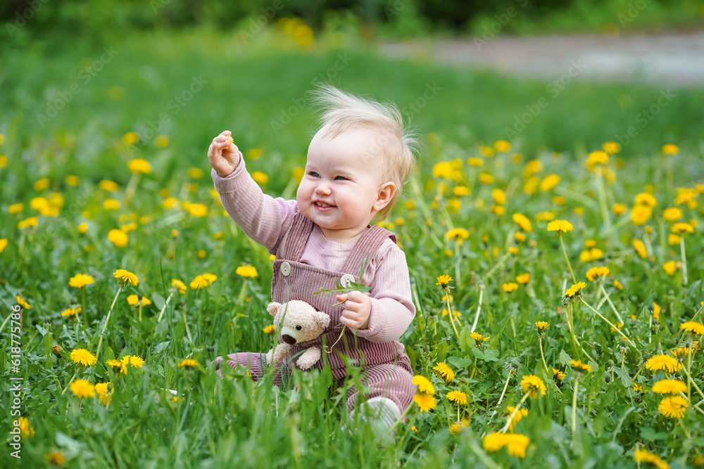 Cute baby sitting in a field of dandelions Cute baby sitting in a field of dandelions