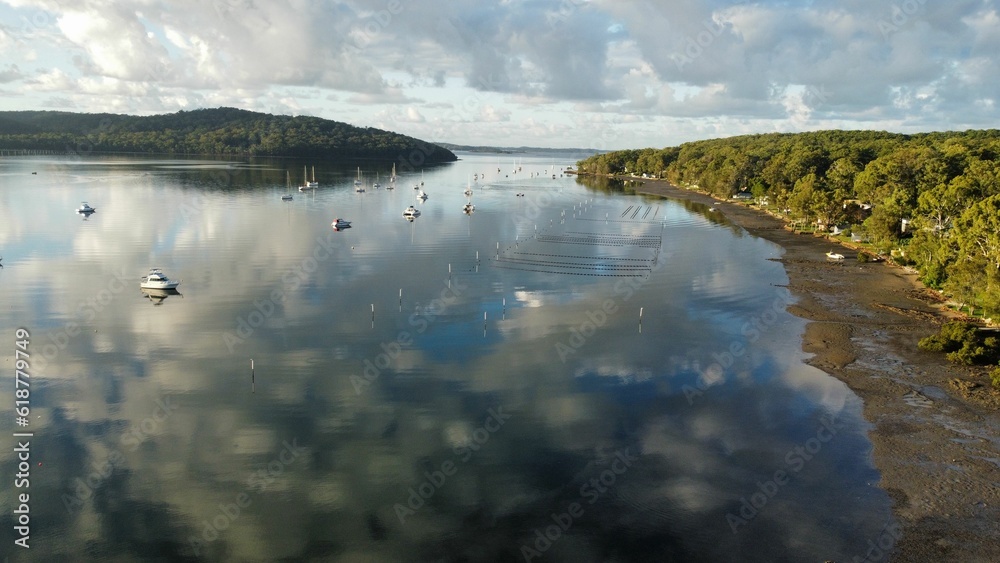 a river in a forest is surrounded by water and clouds