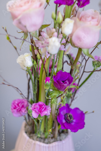 Flower arrangement in pots with purple and pink flowers in the interior