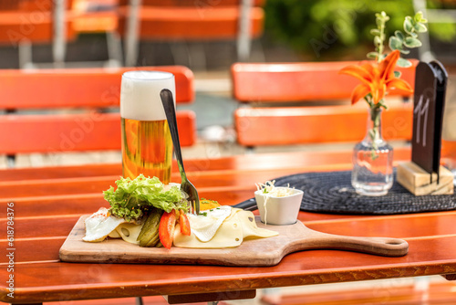 View at a typical bavarian lunch in a beer garden in summer outdoors, regional delicacy during summer season in bavaria