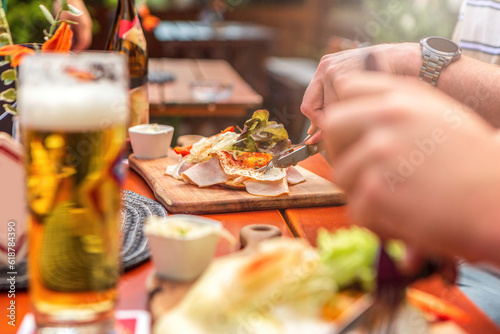 Close-up of a person eating a typical bavarian lunch at a beer garden in summer outdoors