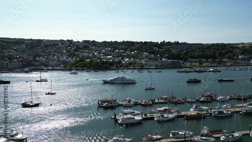 River Dart, South Devon, England: DRONE VIEWS: The drone reverses from the large white yacht, Constance, moored in the middle of the River Dart; Dartmouth and the Royal Naval College are in the b/g. photo