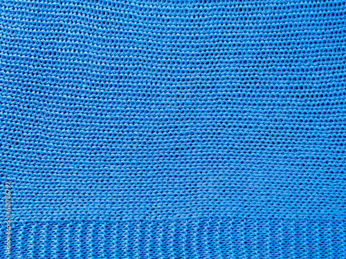 Knitted background.Texture of rough knitting from blue woolen threads