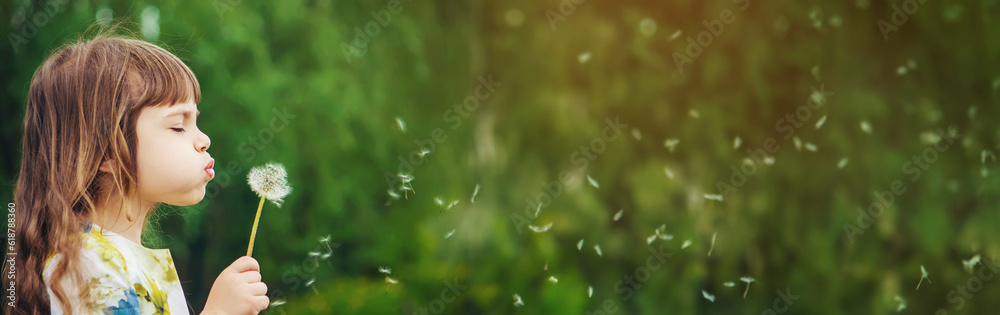 girl blowing dandelions in the air. selective focus. girl blowing dandelions in the air. selective focus.