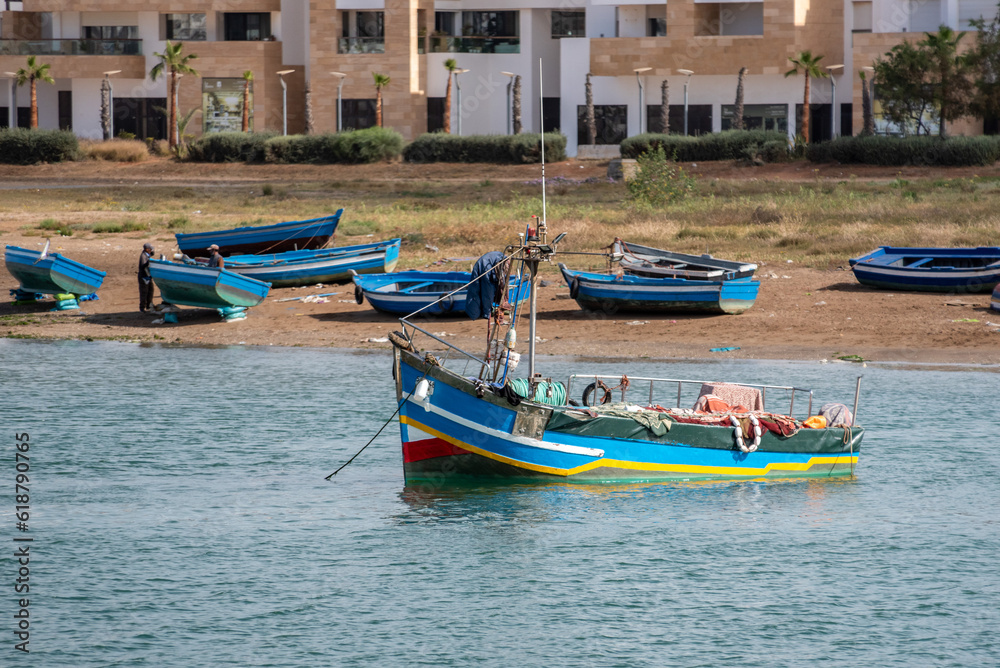 Fototapeta premium An traditionally painted small fisher boat in the harbor of Rabat