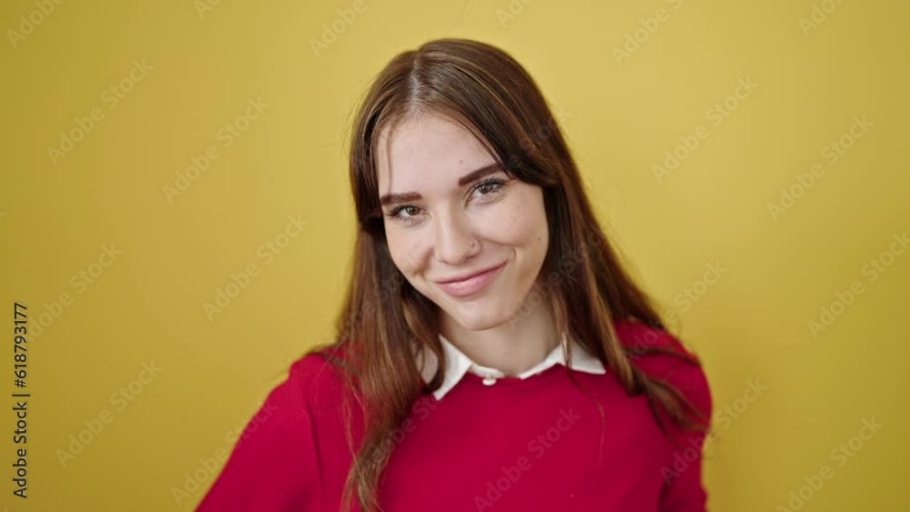 Young hispanic woman smiling confident saying yes with head over isolated yellow background Young hispanic woman smiling confident saying yes with head over isolated yellow background