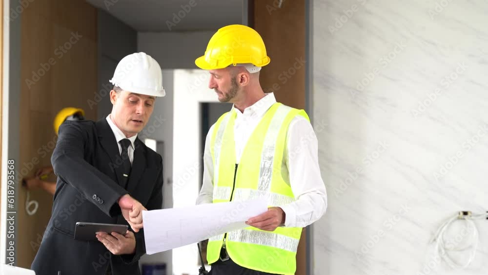 Architect caucasian man working with colleagues mixed race in the construction site. engineer architect wearing safety helmet meeting at construction site. worker Architect caucasian man working with colleagues mixed race in the construction site. engineer architect wearing safety helmet meeting at construction site. worker
