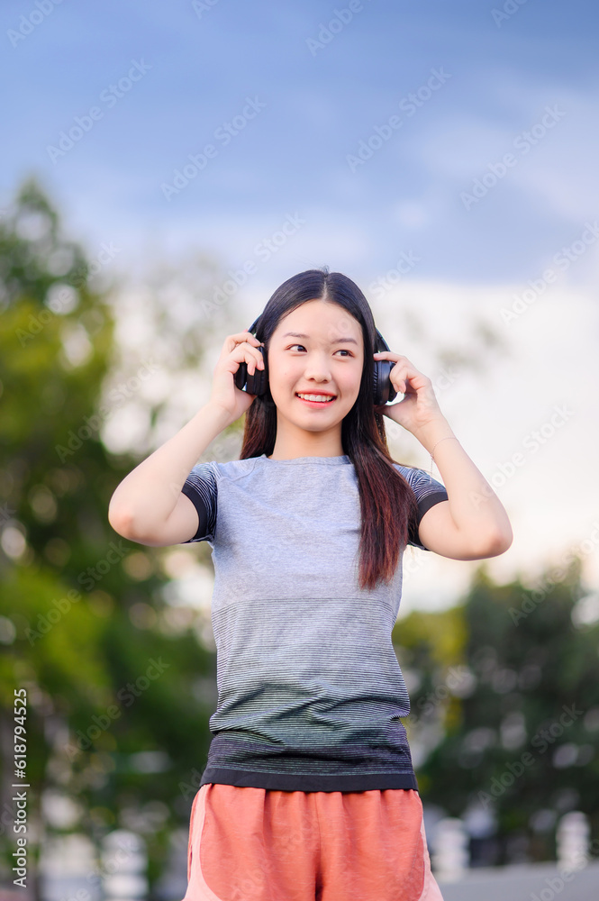 attractive asian woman healthy jogging exercise with headphones in park outdoor at evening attractive asian woman healthy jogging exercise with headphones in park outdoor at evening