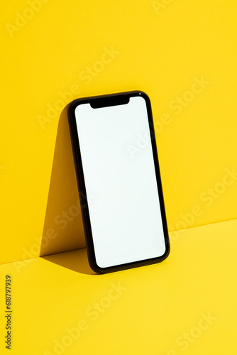 White screen smart phone mockup on yellow background
