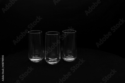 Three glass glasses stand on a black background