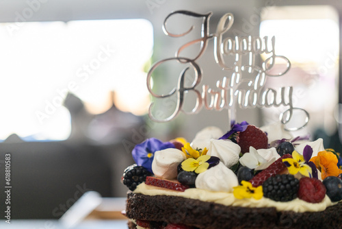 Canvas Print Decorated chocolate cake with berries, flowers, meringue and cream With happy bi