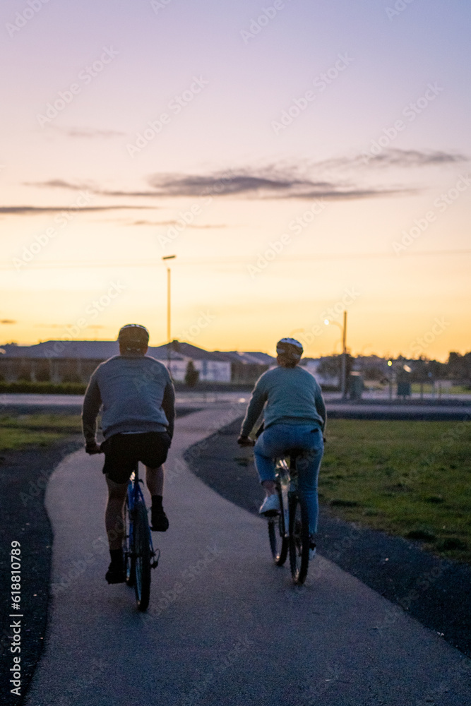 Obraz premium silhouette of two people riding a bike