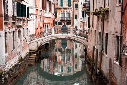 Narrow canal with a bridge in Venice, Italy