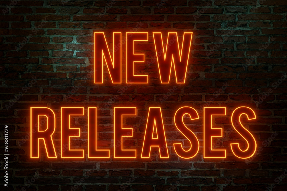 New releases. Brick wall at night, illuminated neon text New releases. Brick wall at night, illuminated neon text