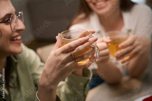 Close up photo of female friends drink tea