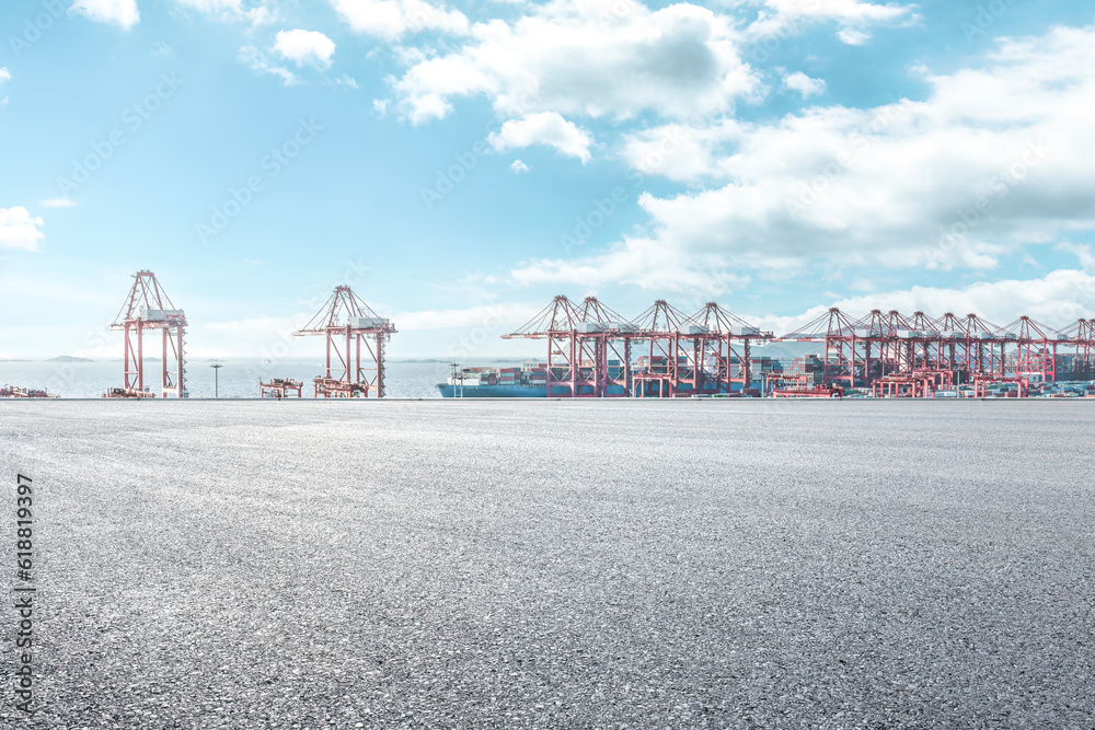 Empty asphalt road and container port background - obrazy, fototapety, plakaty 