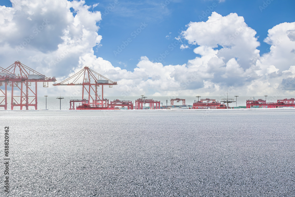 Empty asphalt road and container port background - obrazy, fototapety, plakaty 