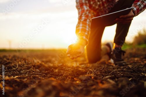 The farmer's hands collects the soil and checks its health before growing the crop. The concept of agriculture, business and gardening.