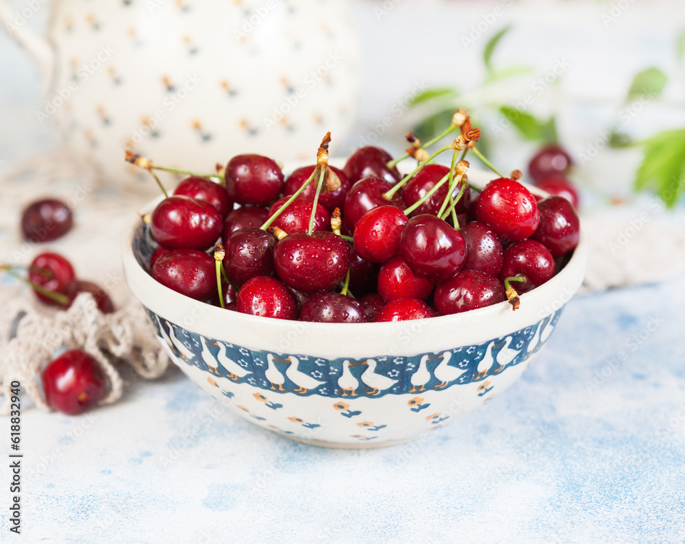 Fresh red cherries in a beautiful ceramic bowl. Selective focus. Fresh red cherries in a beautiful ceramic bowl. Selective focus.