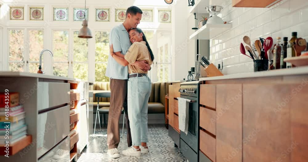 Love, dance and a happy couple in a kitchen at home with happiness, care and romance. Young woman and a man together in an apartment to hug, relax and bond for quality time, security and commitment Love, dance and a happy couple in a kitchen at home with happiness, care and romance. Young woman and a man together in an apartment to hug, relax and bond for quality time, security and commitment
