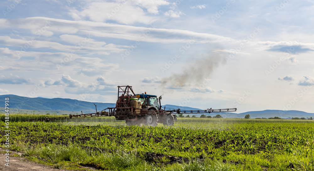 Fototapeta premium Tractor spraying pesticides