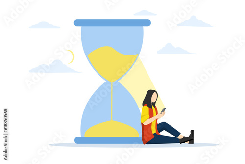 staying up late at night with phone addiction concept, Screen time, rolling doom or wasted time using smartphone, exhausted man sitting with sand glass using smartphone with bright light on his face.