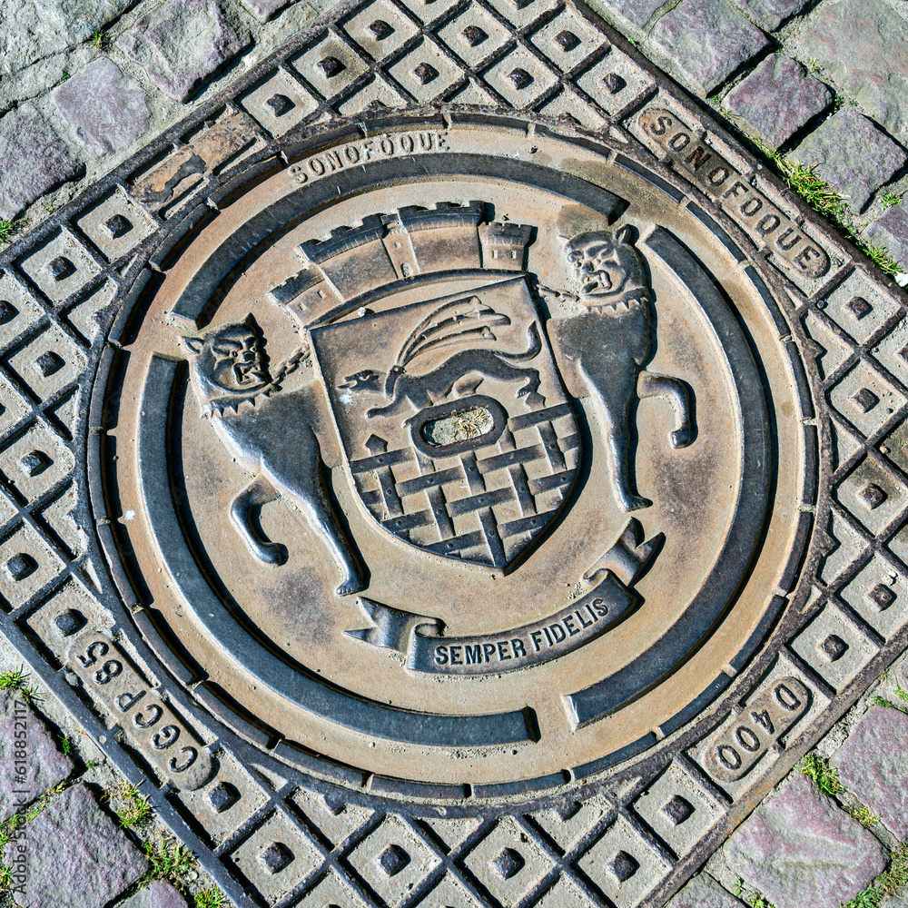  iron manhole covering with coat of arms of the town Sain Malo in Brittany, France