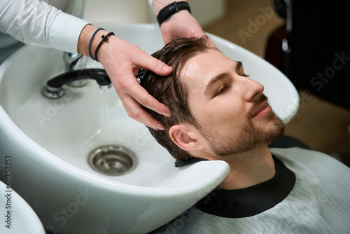 Hairdressing salon client enjoys the process of washing hair