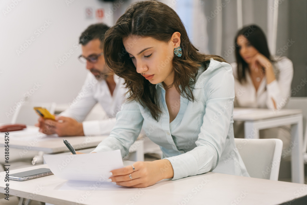 Multigenerational businesspeople having test after presentation at the classroom Multigenerational businesspeople having test after presentation at the classroom
