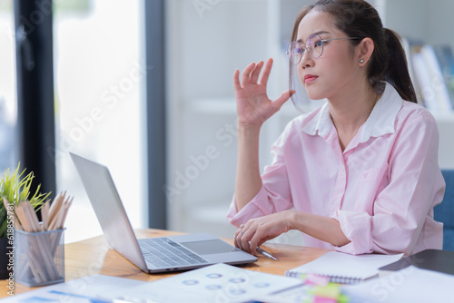 Young woman happy and screaming because of problems with documents in the office.