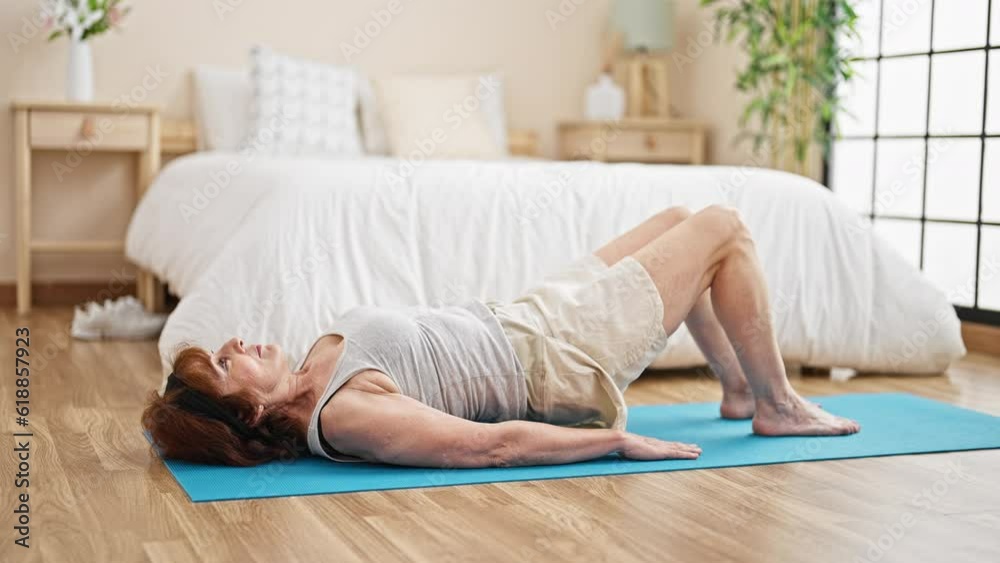 Middle age woman training abs exercise at bedroom Middle age woman training abs exercise at bedroom