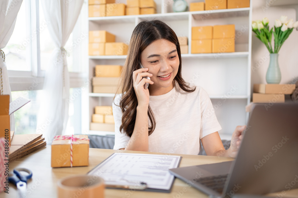 Business owner on the phone talking to a customer, Business owner taking orders from laptop, Packaging and Delivery, Packaging and Shipping. Business owner on the phone talking to a customer, Business owner taking orders from laptop, Packaging and Delivery, Packaging and Shipping.