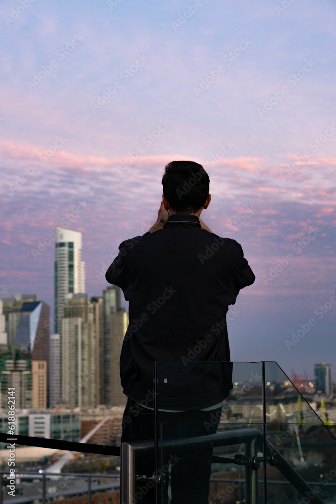 Fototapeta premium Buenos Aires skyline view from rooftop CCK during sunset, man taking photos