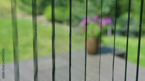 Fly screen door closing, mesh net for bugs and mosquitoes. Concept of protection against annoying insects.