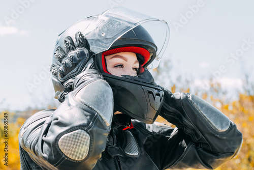 A girl in a motorcycle protective helmet close-up