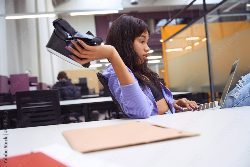 Female employee doing work tasks in modern room