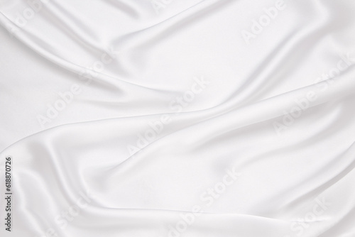 Smooth elegant white silk or satin luxury cloth texture can use as wedding background. Luxurious background design.