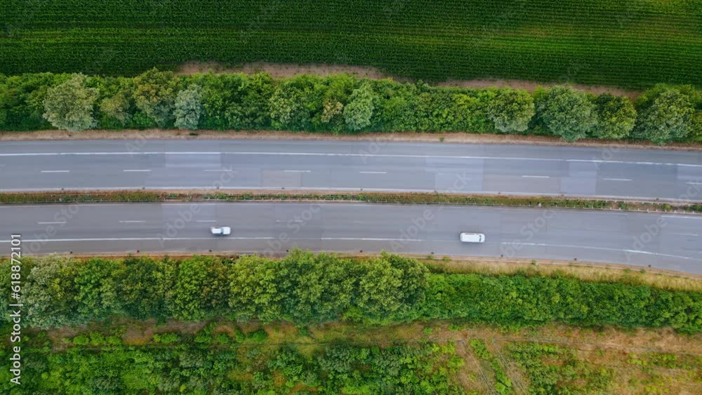 Aerial view of German highway autobahn . Drone shot of highway among forest and green field. Cars fast speed moving on freeway. Aerial view of German highway autobahn . Drone shot of highway among forest and green field. Cars fast speed moving on freeway.