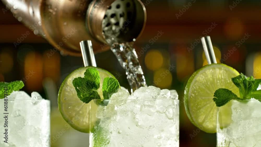 Super slow motion of preparing mojito drink with speed motion. Filmed on high speed cinema camera, 1000 fps, placed on high speed cine bot. Bar with bottles on background. Speed ramp effect.