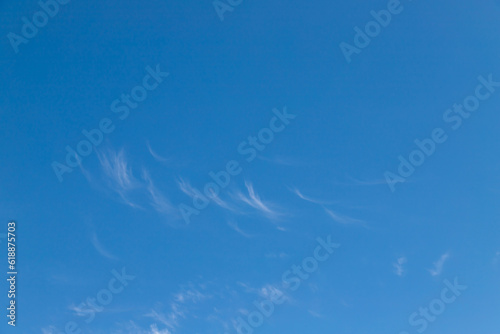Blue sky with a few clouds background.