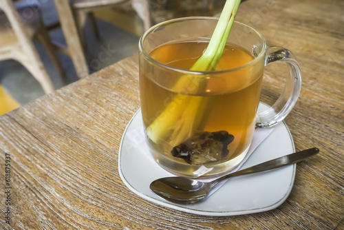 Wedhang Jahe Sere in a glass or Hot Lemongrass Ginger drink is a traditional drink from Java, Indonesia drinks that function as herbal medicines or to overcome body chills. Close-up photo. photo