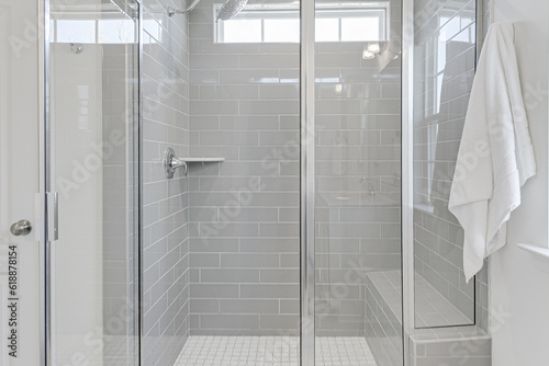 Beautiful Clean modern primary bathroom interior walk in stand in shower with gray subway tile