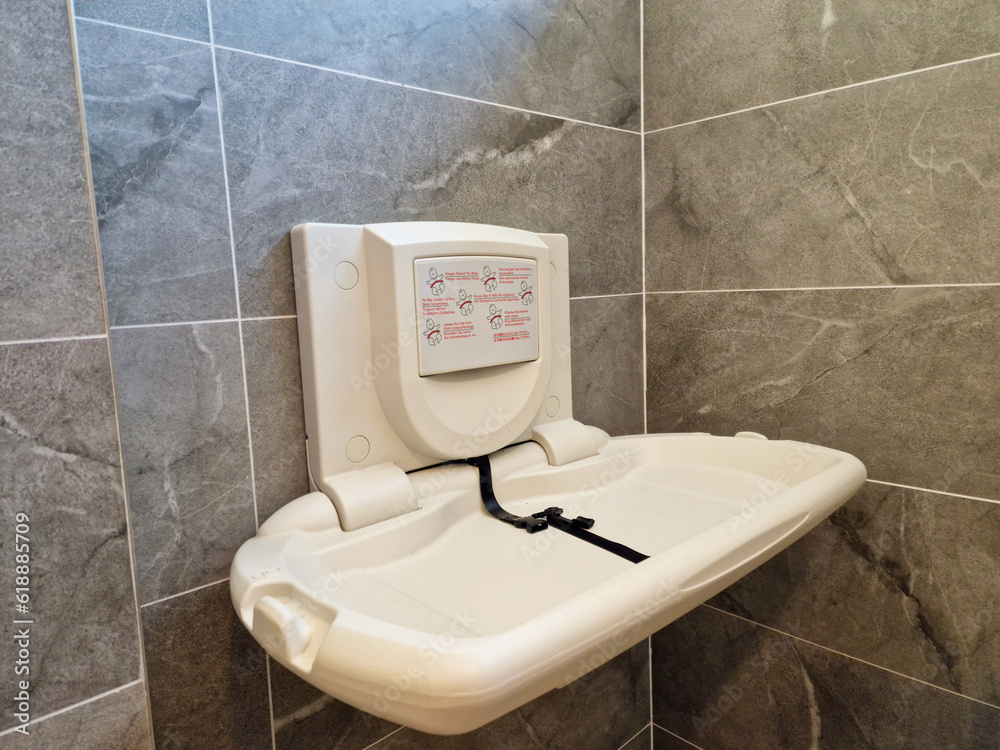 Baby nappy diaper changing table in a public toilet restroom. Child