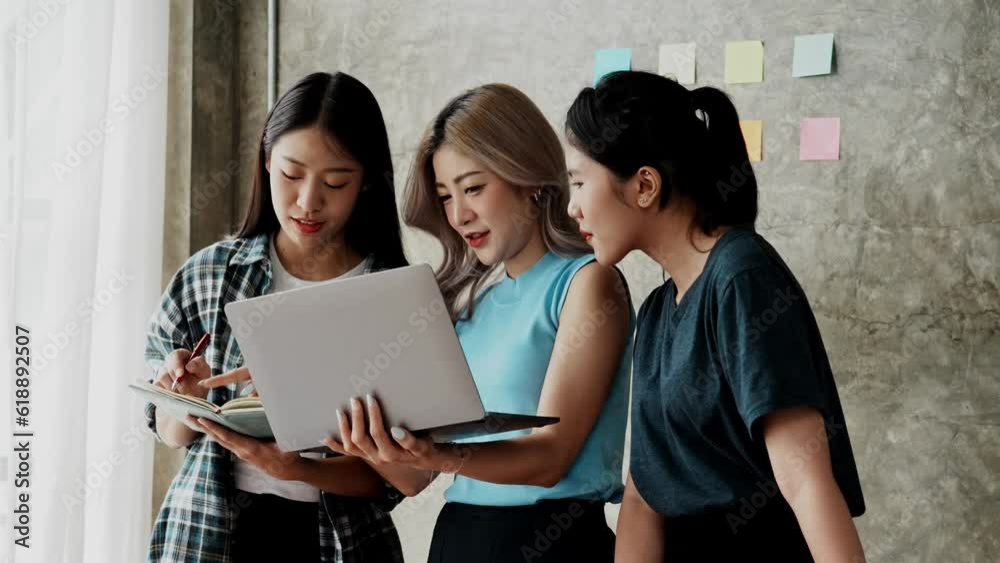 Young happy Asian business woman work together in start up office. Creative team brainstorm meeting, internet technology, businesspeople colleague partnership, or office coworker teamwork concept. Young happy Asian business woman work together in start up office. Creative team brainstorm meeting, internet technology, businesspeople colleague partnership, or office coworker teamwork concept.