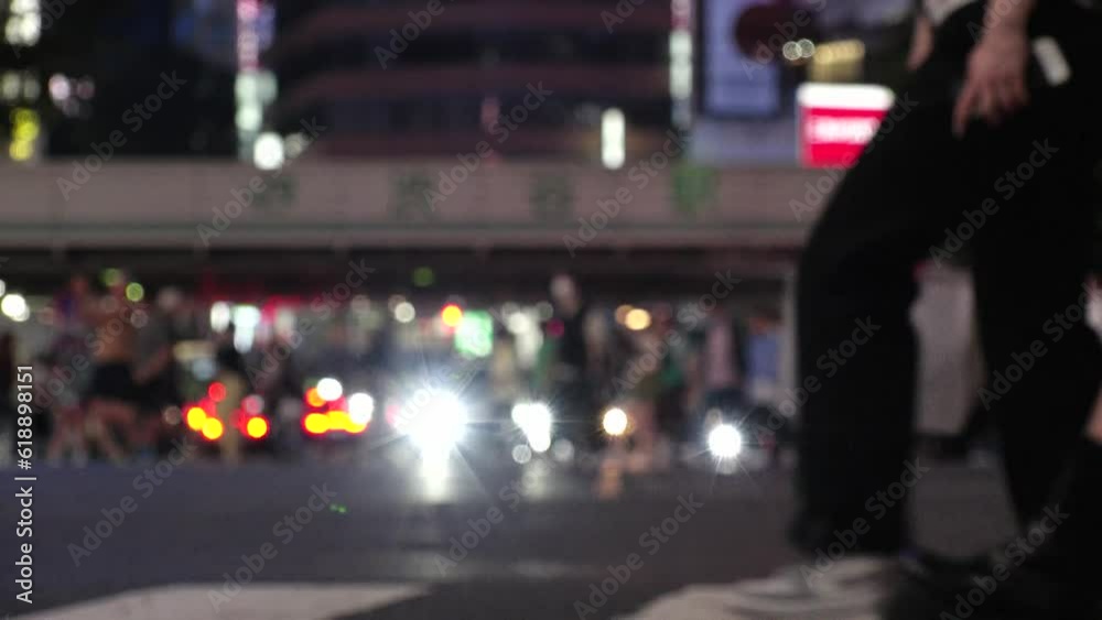 SHIBUYA, TOKYO, JAPAN - JUNE 2023 : View of crowd of people walking at Shibuya crossing at night. Busy downtown area in Tokyo. Japanese people, urban city life and traffic concept 4K video. SHIBUYA, TOKYO, JAPAN - JUNE 2023 : View of crowd of people walking at Shibuya crossing at night. Busy downtown area in Tokyo. Japanese people, urban city life and traffic concept 4K video.
