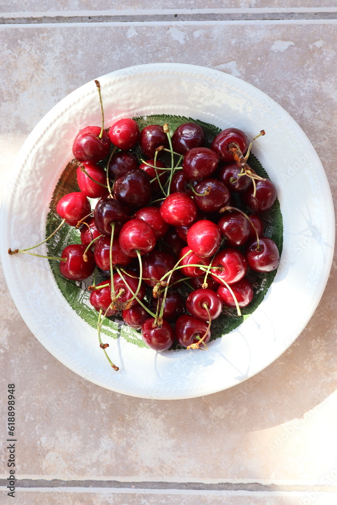 delicious summer fruit cherries in white plate, close-up, natural light view delicious summer fruit cherries in white plate, close-up, natural light view