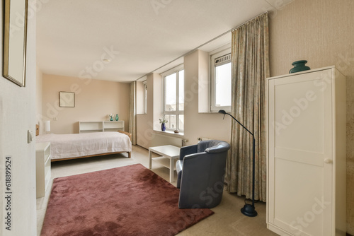 a hotel room with a bed  desk and chair in front of the window looking out into the bedroom area