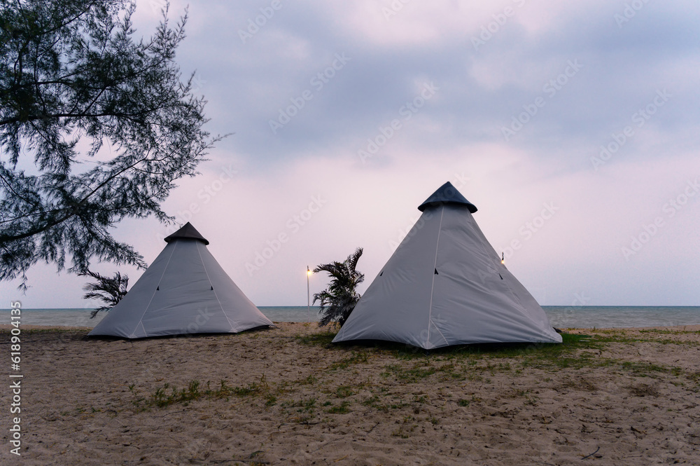 Camping by the Beach with Stunning Ocean Views and Sandy Shoreline, Relaxing by the Ocean in a Serene Camping Teepee Tent, Tranquil Beachscape.