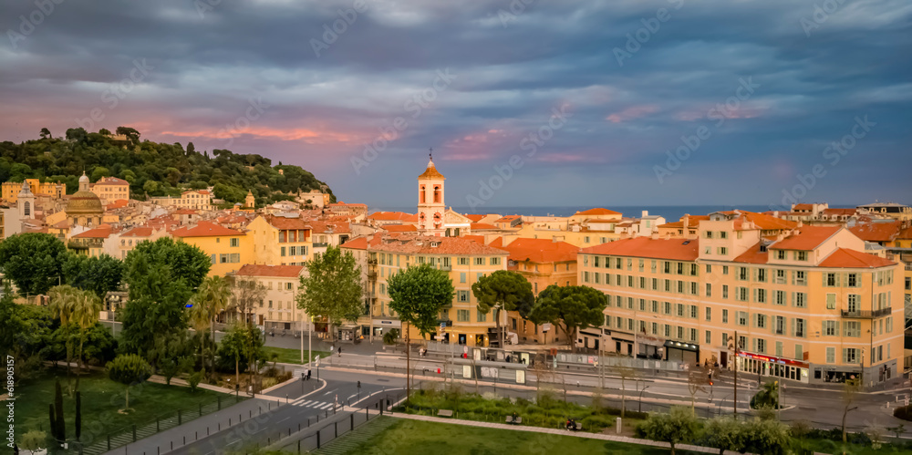 Aerial panoramic view of the streets of Old Town or Vieille Ville and reflecting fountains on Promenade du Paillon at sunset in Nice, France
